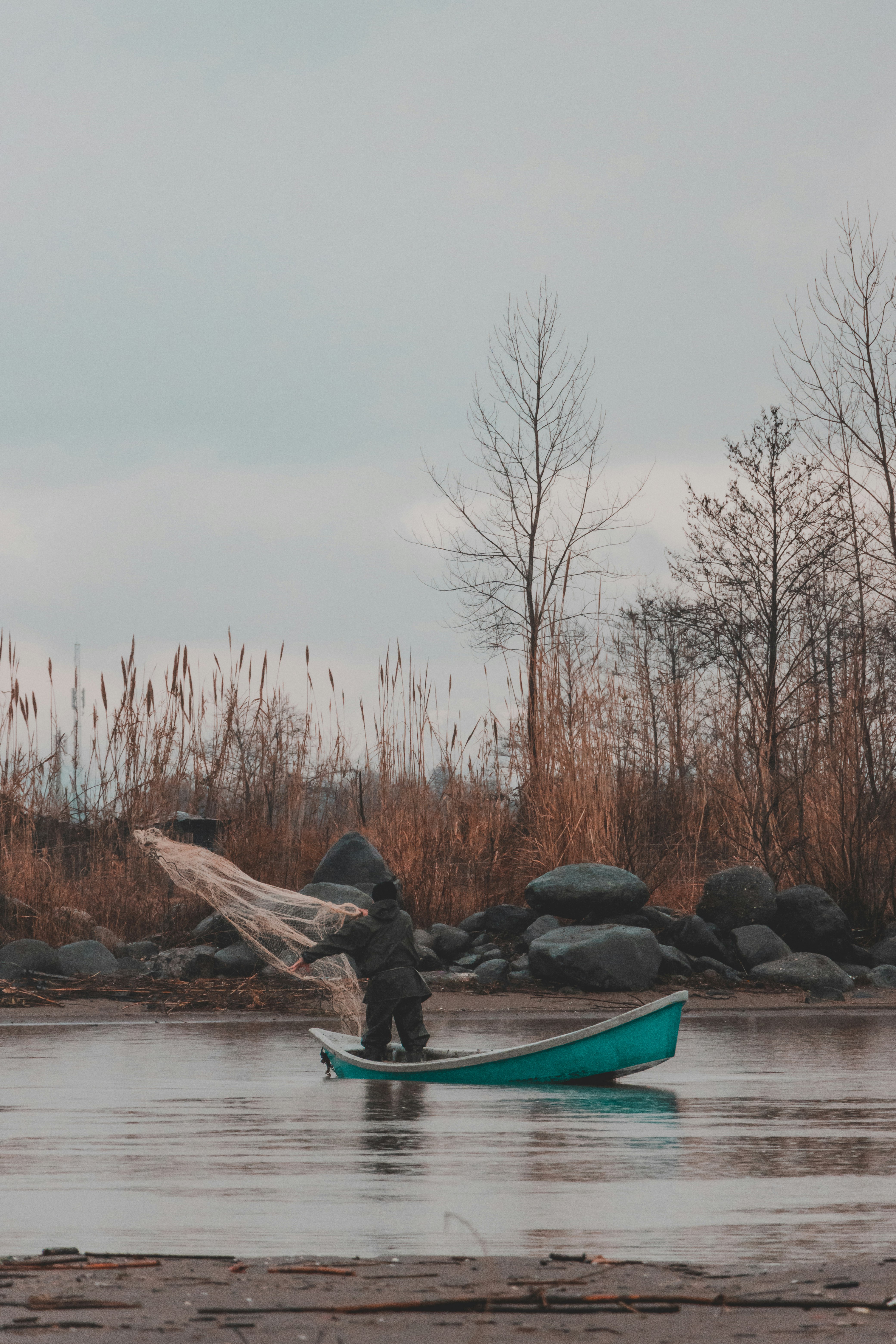 person riding on blue kayak on river during daytime